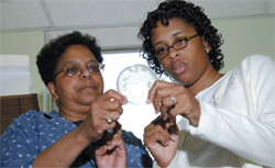 Dr. Margaret Johnson (left) and Courtney Burrell research where a molecule, key in communication, is made. 