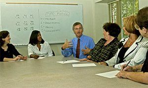 Dr. John Lochman, center, talks with, from left, Dr. Nicole Powell, senior research coordinator in the UA professor's lab; Shanta Burrell, research assistant; and elementary school staff Brenda Cameron (Crestmont Elementary), Carol Glass (Maxwell Elementary), and Mary Guffin (Arcadia Elementary). 