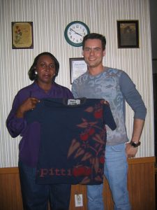 Brian Taylor, Planting Stitches executive director, and Gloria Fortner, display a garment Fortner made by hand for Project Alabama. 