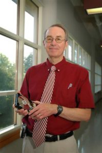 Dr. William "Bill" Butler, shown here holding a hard drive, has directed UA's MINT Center since 2001. (Photo by Laura Shill) 