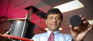 Agrawal holds a piece of hafnium carbide coated carbon foam. He and his collagues are searching for cleaner, quieter combustion processes and are exploring how various types of fuel react within this porous material. (Zach Riggins) 