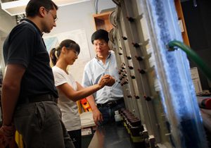 Rui MA, center, a post-doctoral researcher in geological sciences, Dr. Chunmiao Zheng, right, and graduate student Marco Bianchi in a Bevill Building lab. (Photo by Zach Riggins) 