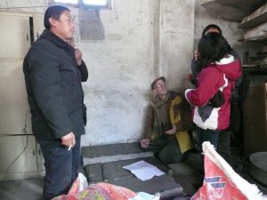 Clark (kneeling) discovered stone tablets in Shanxi province, documenting a 1900 attack on a Catholic village during the famed Boxer Uprising (photo contributed by Clark). 