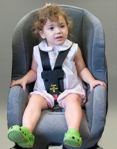 "Sophie" models a new child safety seat latch mechanism. (Samantha Hernandez) 
