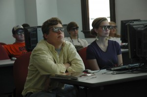 Students wearing 3-D glasses in a Geology 101 laboratory at UA view virtual reality-style images courtesy a new visualization center. (Jessica Maxwell)