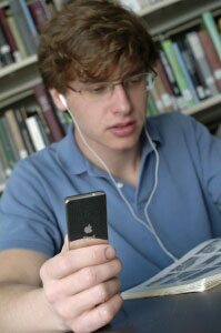 A student listens to Dr. Daniels' “JN 100 On the Go” on an iPod.