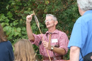 Carl Etheridge of Cartersville, Ga., show visitors how Southeastern Indians fletched their arrows. 