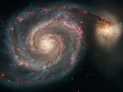 A superb face-on spiral galaxy, The Whirlpool is a popular target for amateur astronomers. This image shows what the NASA / ESA Hubble Space Telescope saw when it observed this classic spiral. Special filters highlight the red glow of enormous hydrogen gas clouds, and this view shows how The Whirlpool is interacting with its much smaller neighbor, the yellow-coloured NGC 5195. (S. Beckwith for the NASA/ ESA Hubble Heritage Team)