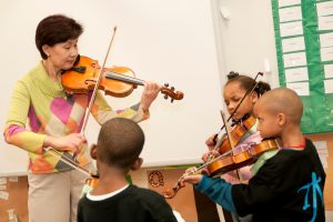 Violin instructor Yang Zhao teaches a music exploratory at Tuscaloosa Middle School. 