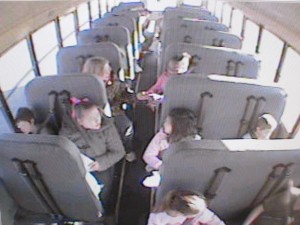 An interior camera shot from one of the school buses outfitted with the new seat belts. Faces of the children have been blurred to protect identity.