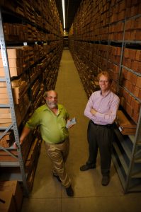 Drs. Jack Pashin, left, and Goodliffe, surrounded by boxed rock samples, in one of six aisles within the Alabama Geological Survey's core warehouse. 