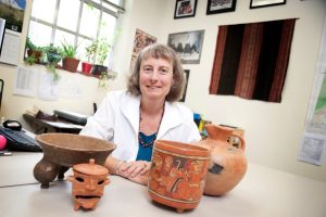 LeCount sits at her desk behind examples of modern and ancient Maya pottery. She has studied the Maya culture since 1992 (Jeff Hanson). 