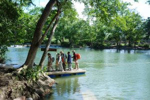 Rafting across the Mopan River is part of the researchers' daily work commute. 