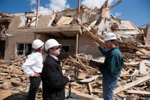 Dr. David Grau, left, van de Lindt, center, and Graettinger analyze tornado-damaged structures in a research effort to design safer homes in the future (Jeff Hanson). 