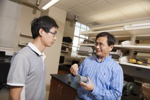 Dr. Jialai Wang, right, and Shixin Zeng work with fly ash material in the lab.