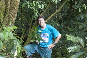 Clark stands near the trees, known as Shuaria ecuadorica. 