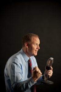 Billings displays his enthusiasm for sports communication in this photo illustration. 
