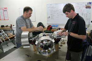 Alabama Lunabotics team members Michael Carswell, left, and Caleb Leslie work on the lunabot in space provided for engineering student projects. 