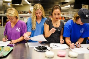Students study the various components of different types of yogurt and applesauce during a recent food science course at The University of Alabama. 