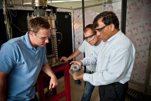 Dr. Ajay Agrawal, right, with graduate students Justin Williams, left, and Joseph Meadows examine the noise reduction device, or noise sponge, in 2012.