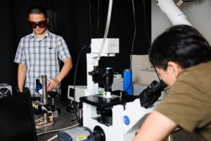 Zhichao Shan, left, and Jia Liu are shown in Pan's laboratory. Pan seeks a better understanding of how organic solar cells work at the molecular level (Matthew Wood). 