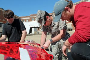 Aerospace engineering students, from left, Chris Cottingham, Daniel Groff and Derrick Talley prepare the aircraft for testing. 