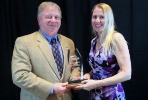 Lisa McKinney receives award from Dr. Greg Carnes 