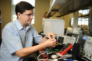 Dr. Edward Sazonov, associate professor of electrical and computer engineering, demonstrates sensor technology in a lab at The University of Alabama. 