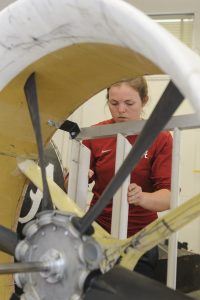 Ashley Allison, a senior in aerospace engineering and mechanics at The University of Alabama, works on the UA Hoverteam's craft earlier this semester.