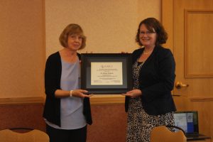Dr. Melissa Wilmarth, right, receives the Emerging Scholar Award for 2014 from the Family & Consumer Sciences Research Journal. 