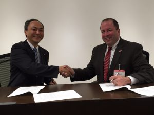 Dr. Kyung-Ku Choi, left, and Dr. Carl A. Pinkert shake hands following the signing of a new UA-TDK cooperative research agreement. 