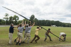 A team with the National Civilian Community Corps, an AmeriCorps program, hoist the entrance drums for the Moundville Native American Festival. 