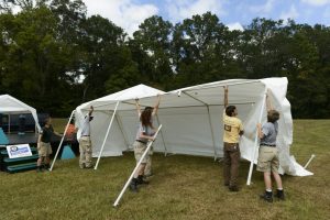 A team with the National Civilian Community Corps, an AmeriCorps program, erect a tent for the Moundville Native American Festival, which kicks off Oct. 7. 
