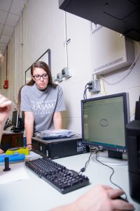 Pam Zierdt, a student studying aerospace engineering, examines a solid model of a thruster in Dr. Richard Branam's lab on the UA campus (Miriam Brandt). 