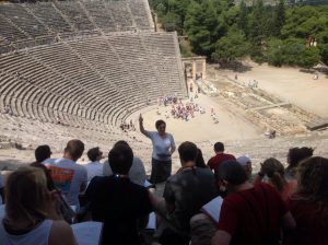 Dr. Tatiana Tsakiropoulou-Summers teaching students at the theater of Epidaurus in Greece. 