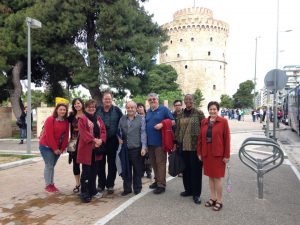 Dr. Tatiana Tsakiropoulou-Summers (in red shirt) and a cohort of UA and Aristotle University professors in front of Thessaloniki's trademark Medieval building, the White Tower in Greece. 
