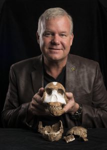 Dr. Lee Berger holds the skull from Homo naledi. 