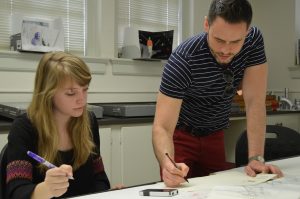 Taylor, right, works with a student on sketches. 