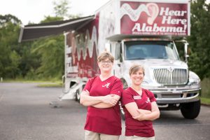 Dr. Marcia Hay-McCutcheon (right) with JoAnne Payne, an audiologist with Hear Here Alabama mobile hearing center, stand in front of the center in Selma.