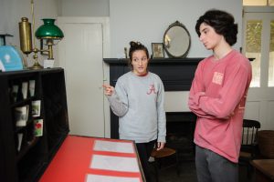 Student volunteer Tara Williams, a senior majoring in history, gives a tour of the Gorgas House Museum to freshman Samuel Nettleton. 