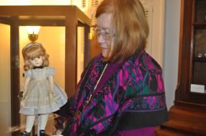 Dr. Virginia Wimberley readies dolls for the display case.