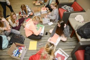 UA students write letters and assemble care packages. 