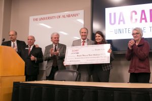 UA President Stuart R. Bell, fourth from left, and United Way of West Alabama President and CEO Jackie Wuska hold the ceremonial check that was presented to Wuska during the Dec. 8 celebration of another successful UA United Way campaign. Celebrating with them are, from left, Craig Edelbrock and campaign co-chairs Robert Prescott, Bill Elrod and Dixie MacNeil.