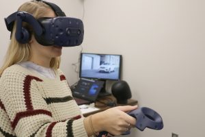 Woman wearing virtual reality goggles.