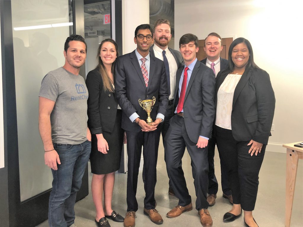 From left to right: Marco Nelson of RentCheck, Jessica Hastings, Sudarsan Murali, Dalton Kerby, Landon Robertson, Spencer Adams, and Laci Williams celebrate their first place victory.