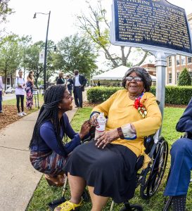 This is a photo of Autherine Lucy Foster in front of a historic marker honoring her. 