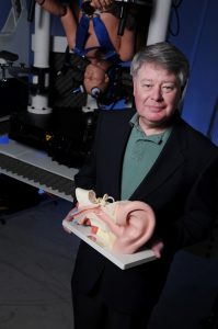 UA's Dr. Craig Formby with a 3D model of the human ear.