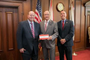 Alabama Power's Mark Crews makes a presentation to UA President Stuart R. Bell and Dr. Russell Mumper. 