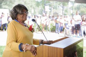 A photo of Autherine Lucy Foster speaking at the podium.