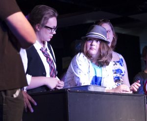 Theatre actors, ages 10-17, perform lines during a feature performance.